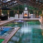 Indoor Outdoor Pool with Glass Walls and Firepla