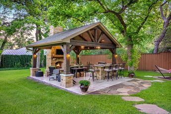 This freestanding covered patio with an outdoor kitchen and .