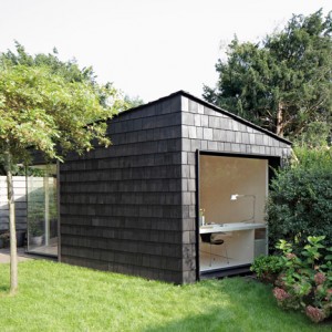 Garden studio has a dark, rough exterior and a light-filled interi