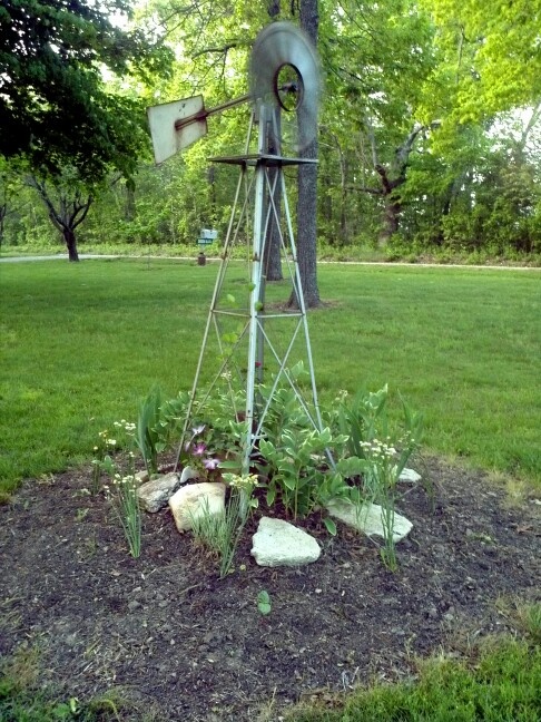 This flower bed is actually hiding our well. And, the windmill is .