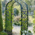 Freestanding metal rose arches with planters, ideal for rooftop .