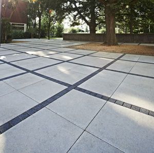 dress up the gaps in the concrete paving slabs with mosaic tiles .